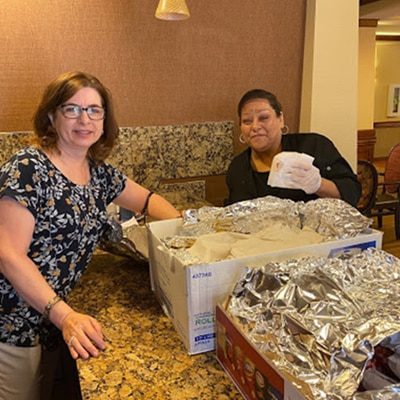 Two ladies unboxing Schwartz's food